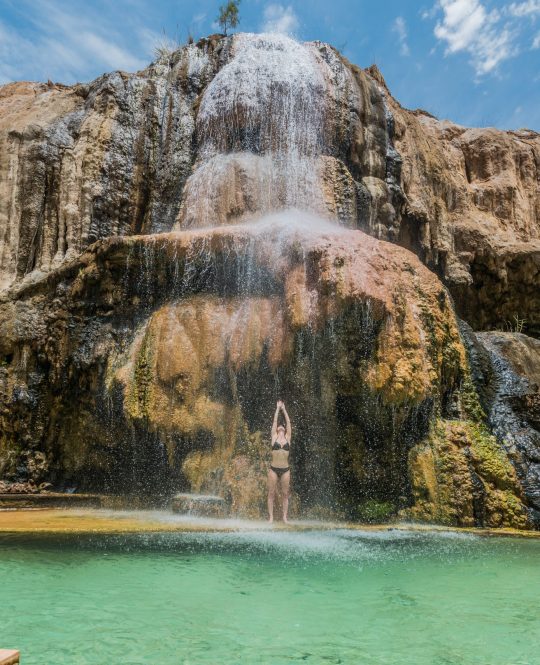 one woman bathing at ma'in hot springs waterfall in jordan middle east